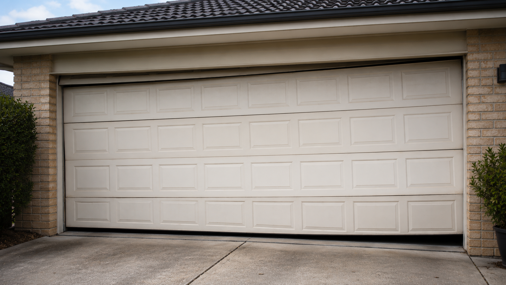 Garage door needing repair due to uneven or failing sections